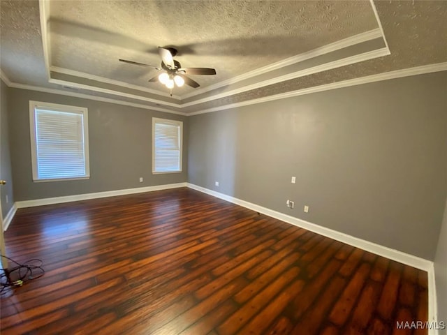 spare room with hardwood / wood-style flooring, ceiling fan, crown molding, and a tray ceiling