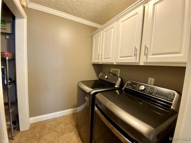 washroom with cabinets, a textured ceiling, separate washer and dryer, and ornamental molding