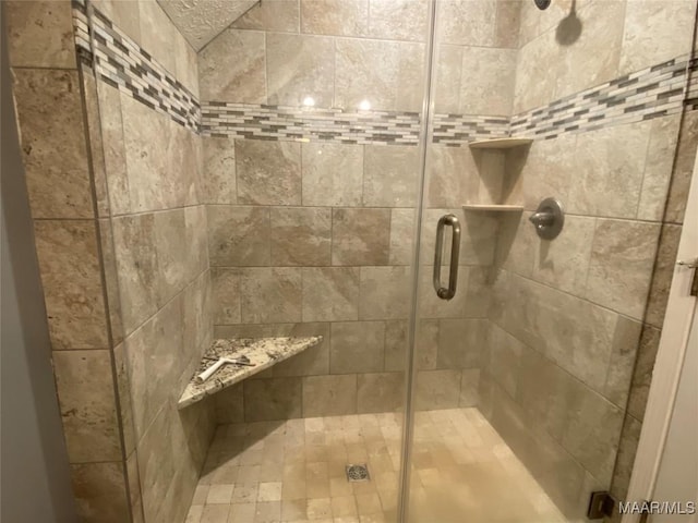 bathroom with a shower with shower door