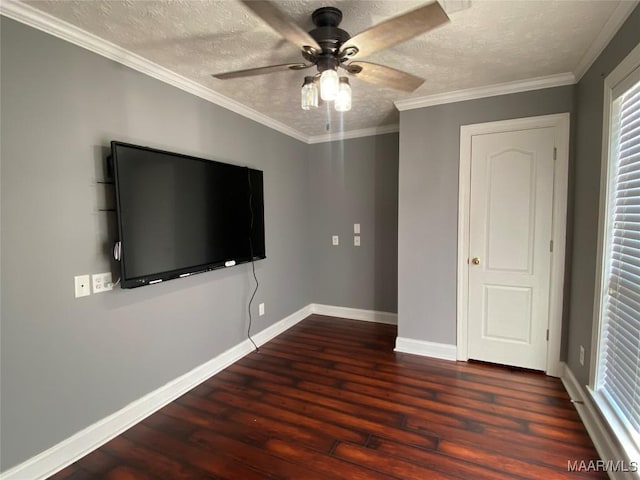 unfurnished bedroom with dark hardwood / wood-style flooring, a textured ceiling, ceiling fan, and crown molding