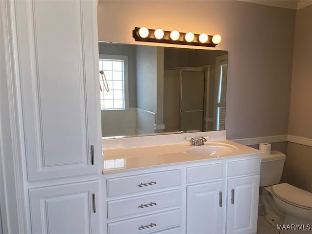 bathroom with vanity, toilet, and walk in shower