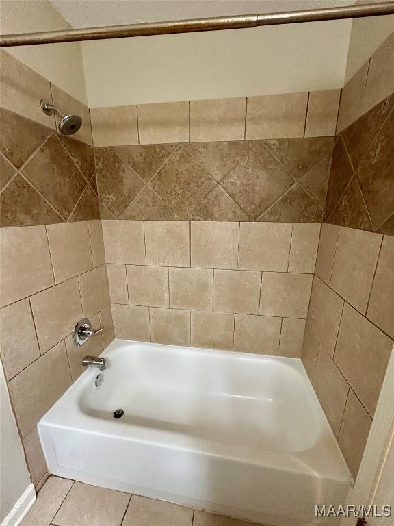 bathroom with tile patterned flooring and tiled shower / bath combo