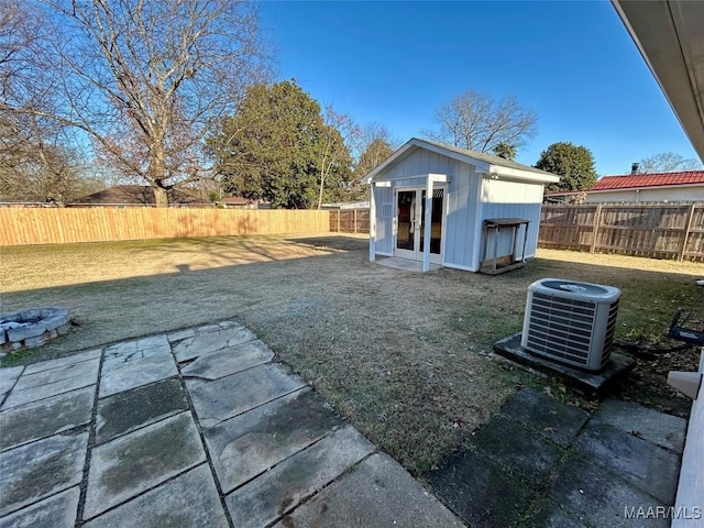 view of yard with central AC and an outdoor structure