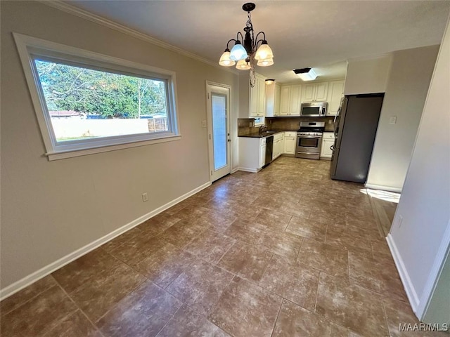 kitchen featuring white cabinetry, sink, stainless steel appliances, an inviting chandelier, and pendant lighting