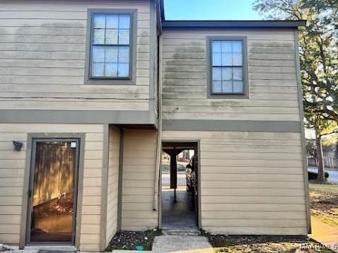 rear view of property with a fireplace