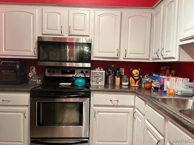 kitchen with sink, white cabinets, and stainless steel appliances