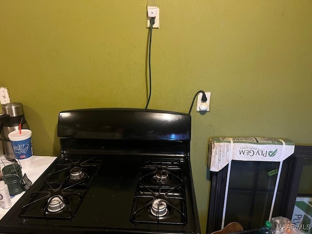 interior details with black range with gas cooktop