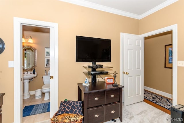 bedroom with ensuite bathroom, light tile patterned floors, and crown molding