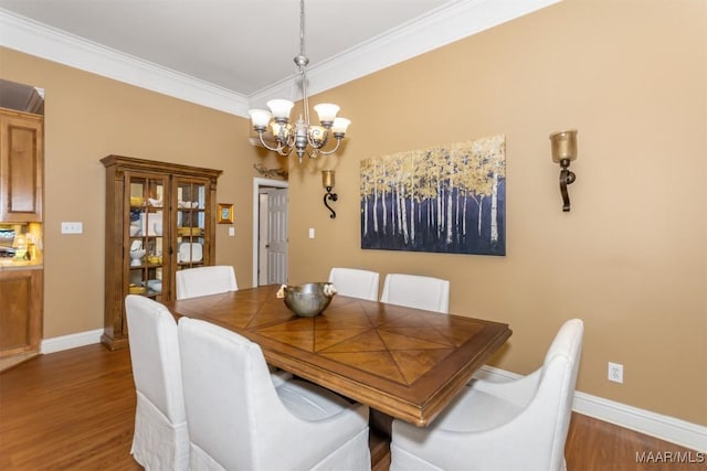 dining area featuring a chandelier, crown molding, and dark wood-type flooring