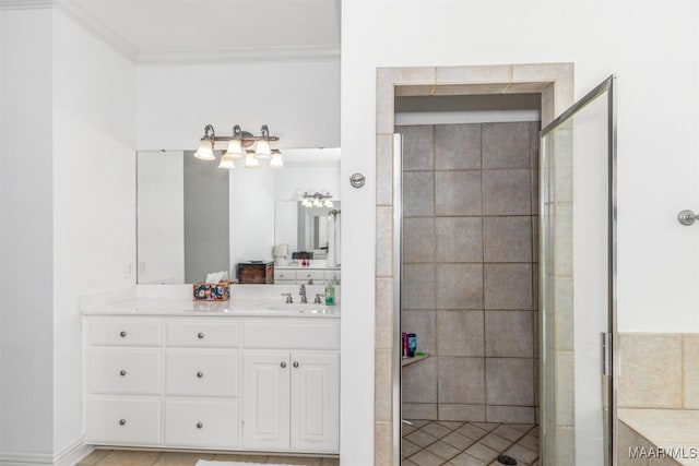 bathroom featuring an enclosed shower, crown molding, and vanity