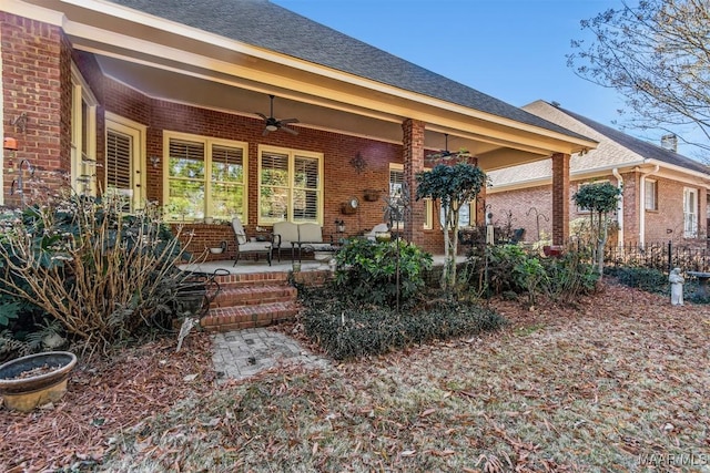 rear view of property featuring ceiling fan