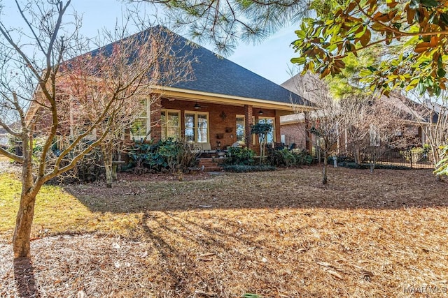 rear view of property featuring covered porch