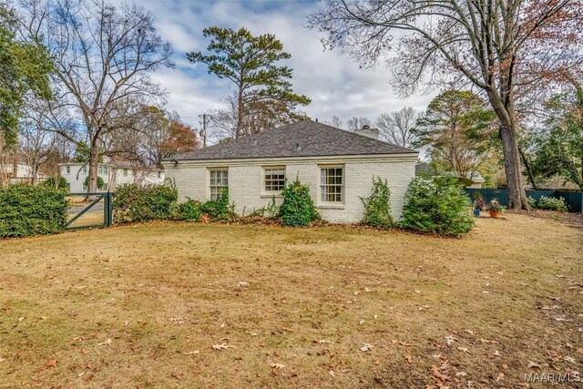 rear view of property with a lawn