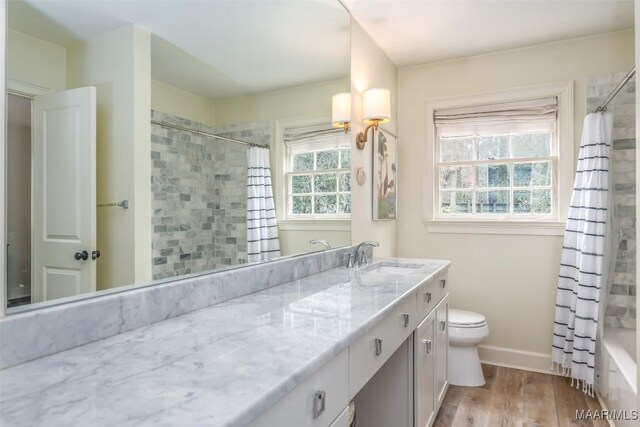 full bathroom with vanity, wood-type flooring, shower / bath combination with curtain, and toilet