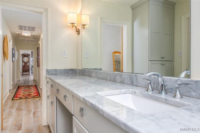 bathroom with vanity, visible vents, and wood finished floors