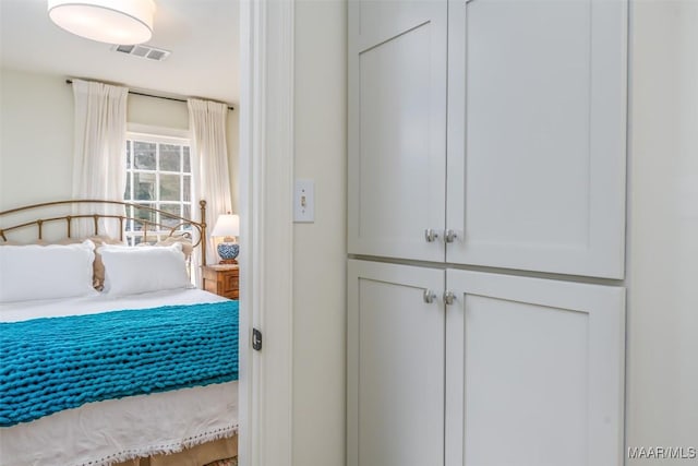 bedroom featuring visible vents