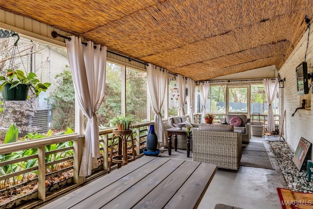 sunroom with a wealth of natural light and concrete floors