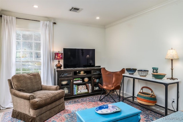 living area with ornamental molding, recessed lighting, and visible vents
