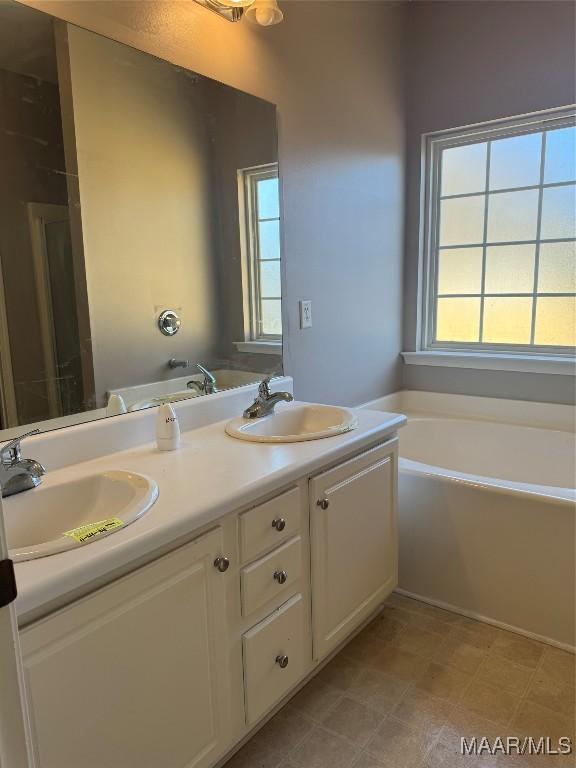 bathroom featuring a bathing tub and vanity