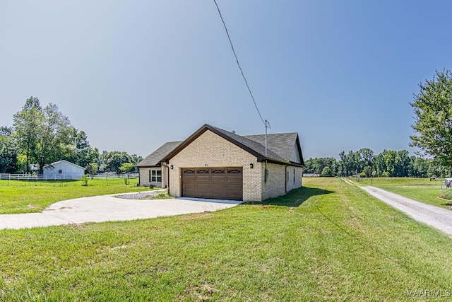 view of home's exterior featuring a garage and a lawn