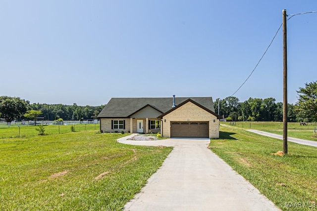 view of front of property featuring a garage, a rural view, and a front yard