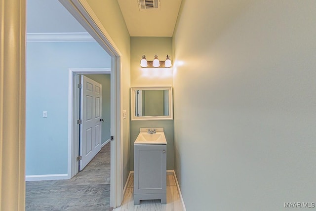 bathroom featuring vanity and crown molding