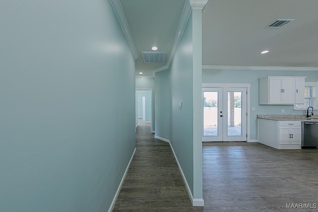 corridor with ornamental molding, french doors, and dark hardwood / wood-style floors