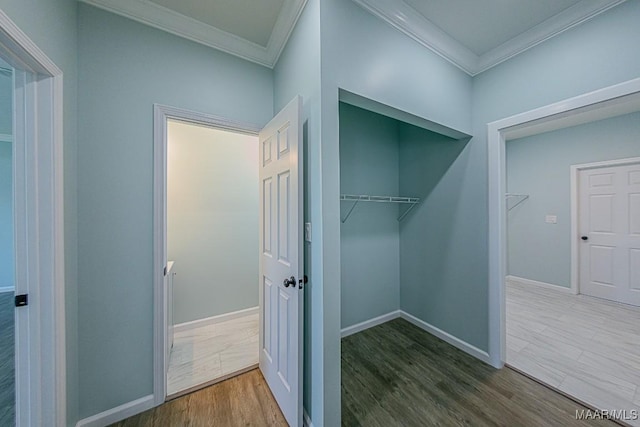 corridor with ornamental molding and dark hardwood / wood-style floors