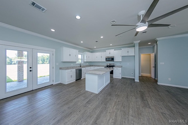 kitchen with stainless steel appliances, french doors, white cabinets, and sink