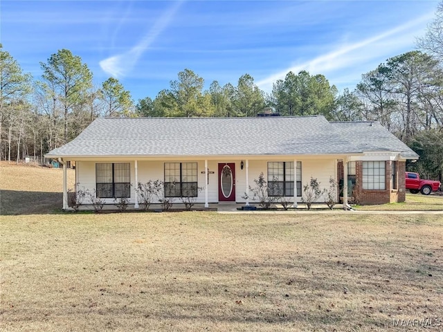 ranch-style home featuring a front yard and covered porch