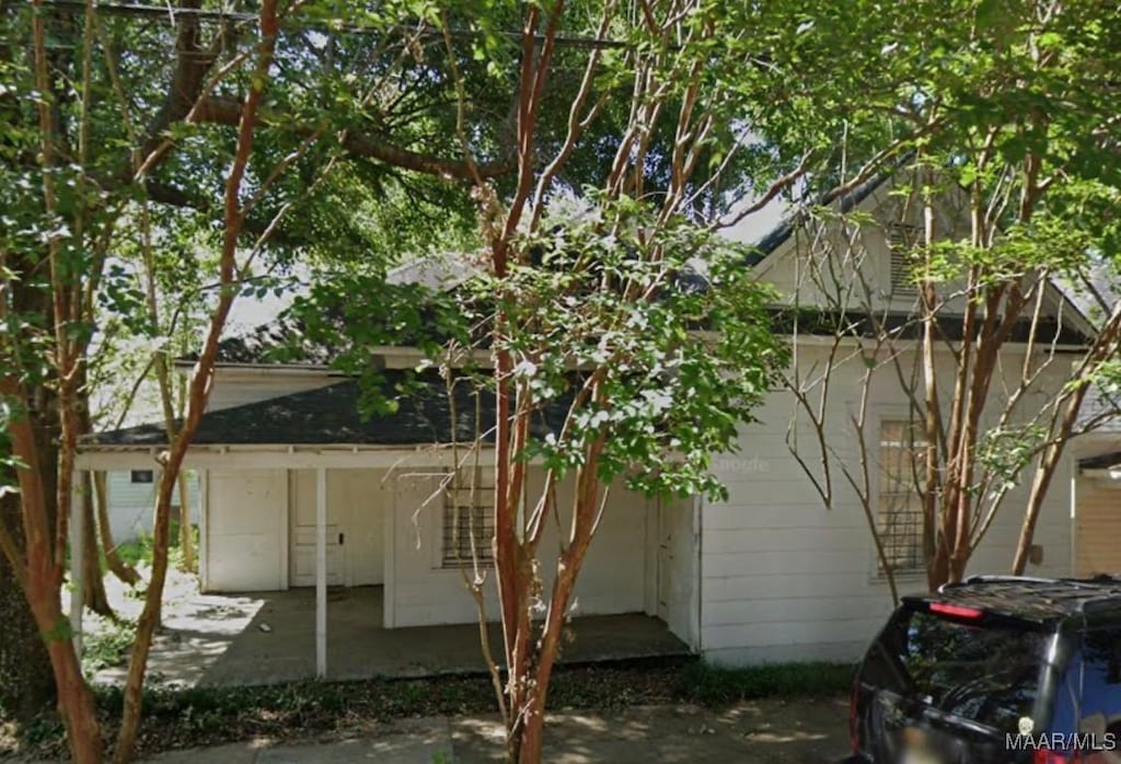 view of property exterior with a patio area