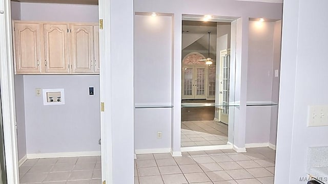 washroom featuring washer hookup, ceiling fan, cabinets, and light tile patterned flooring