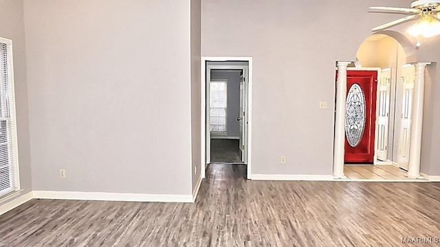 entrance foyer featuring decorative columns, ceiling fan, and light hardwood / wood-style flooring