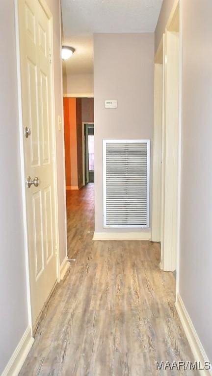 hallway featuring hardwood / wood-style flooring