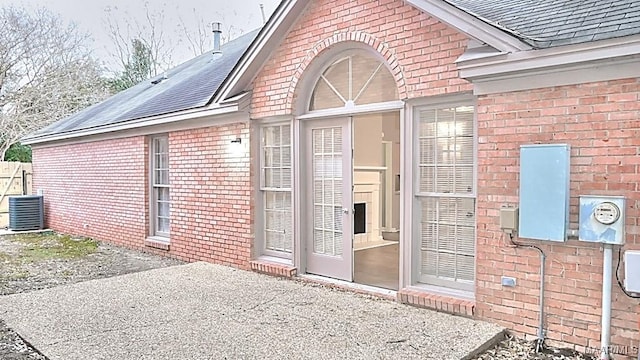 entrance to property with cooling unit and a patio