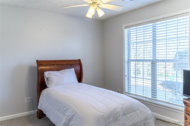 carpeted bedroom with multiple windows and ceiling fan