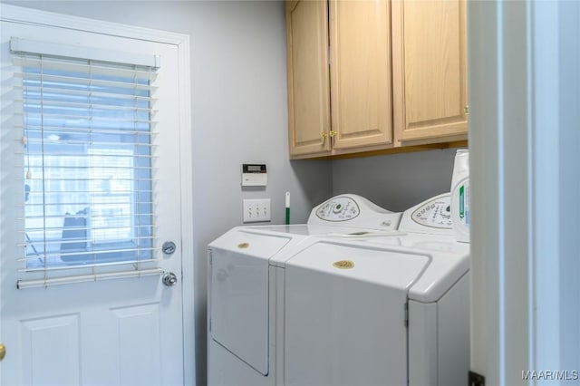 laundry room with cabinets and washing machine and clothes dryer