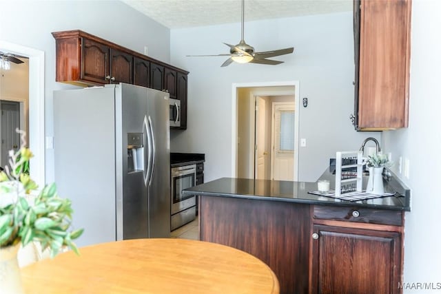 kitchen with dark brown cabinetry, ceiling fan, appliances with stainless steel finishes, and a textured ceiling