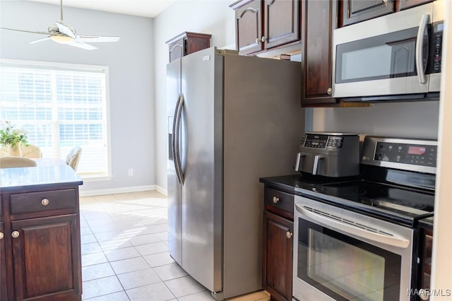 kitchen with ceiling fan, appliances with stainless steel finishes, dark brown cabinetry, and light tile patterned floors