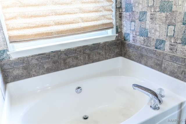 bathroom with a healthy amount of sunlight and a bathtub