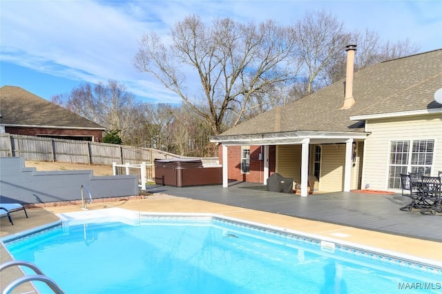 view of pool with a hot tub and a patio