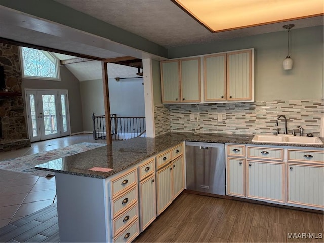 kitchen with dishwasher, kitchen peninsula, pendant lighting, sink, and tasteful backsplash