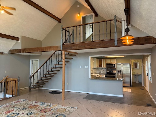 interior space featuring high vaulted ceiling, ceiling fan, tile patterned floors, and sink