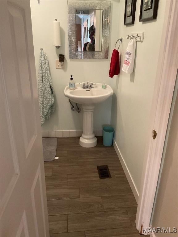 bathroom with hardwood / wood-style floors