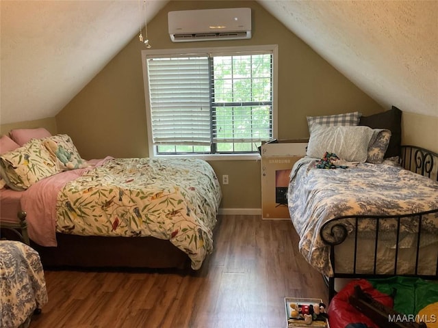 bedroom featuring a textured ceiling, a wall mounted AC, hardwood / wood-style floors, and lofted ceiling