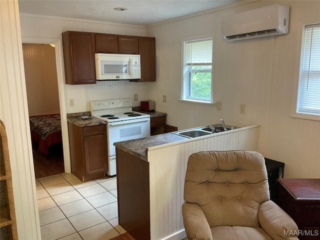 kitchen with white appliances, a wall mounted AC, light tile patterned floors, ornamental molding, and sink