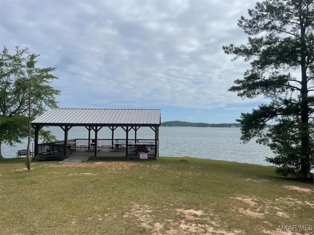 view of dock featuring a lawn, a gazebo, and a water view