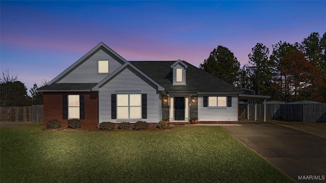 view of front of home featuring a yard and a carport