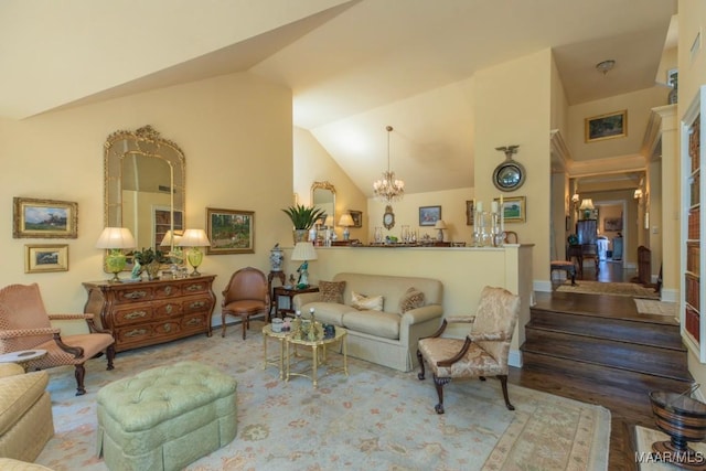 living room featuring hardwood / wood-style floors, vaulted ceiling, and a chandelier