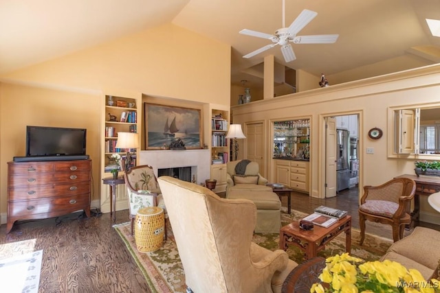 living room with ceiling fan, high vaulted ceiling, dark hardwood / wood-style floors, and built in shelves